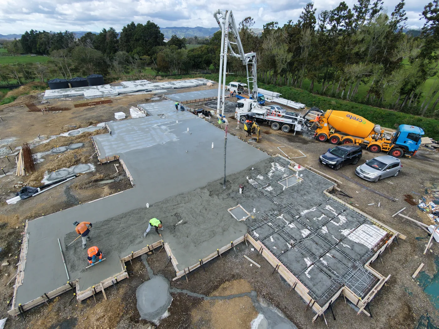 GTD Construction crew screeding wet concrete on a new foundation slab